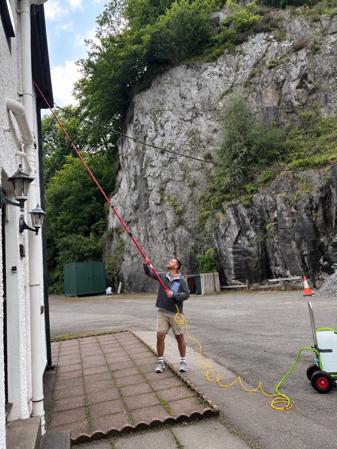 West Coast Window Cleaning using a water-fed pole to clean a property in Oban